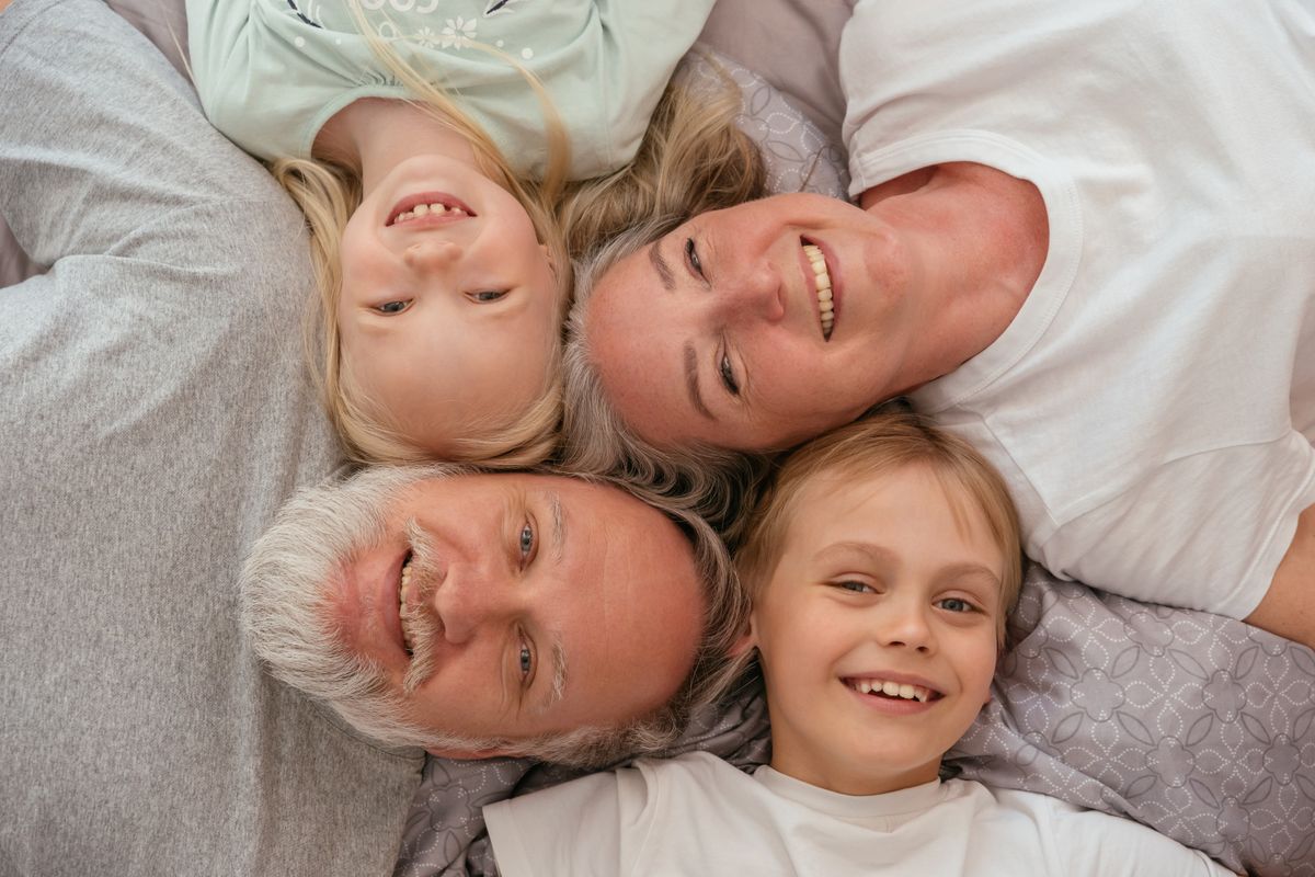 A multigenerational family smiling together at home